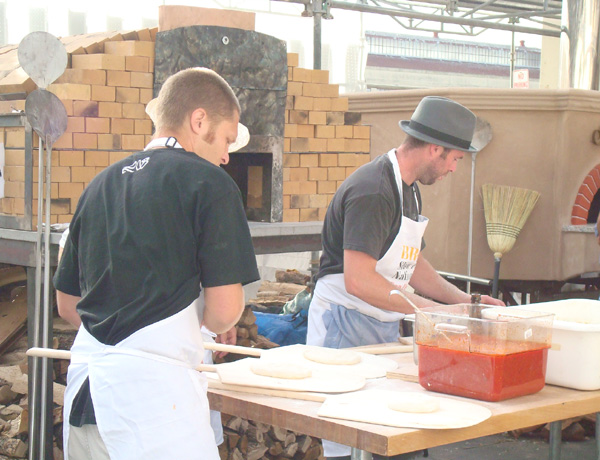 Making pizza margherita at the outdoor breads tasting pavilion.