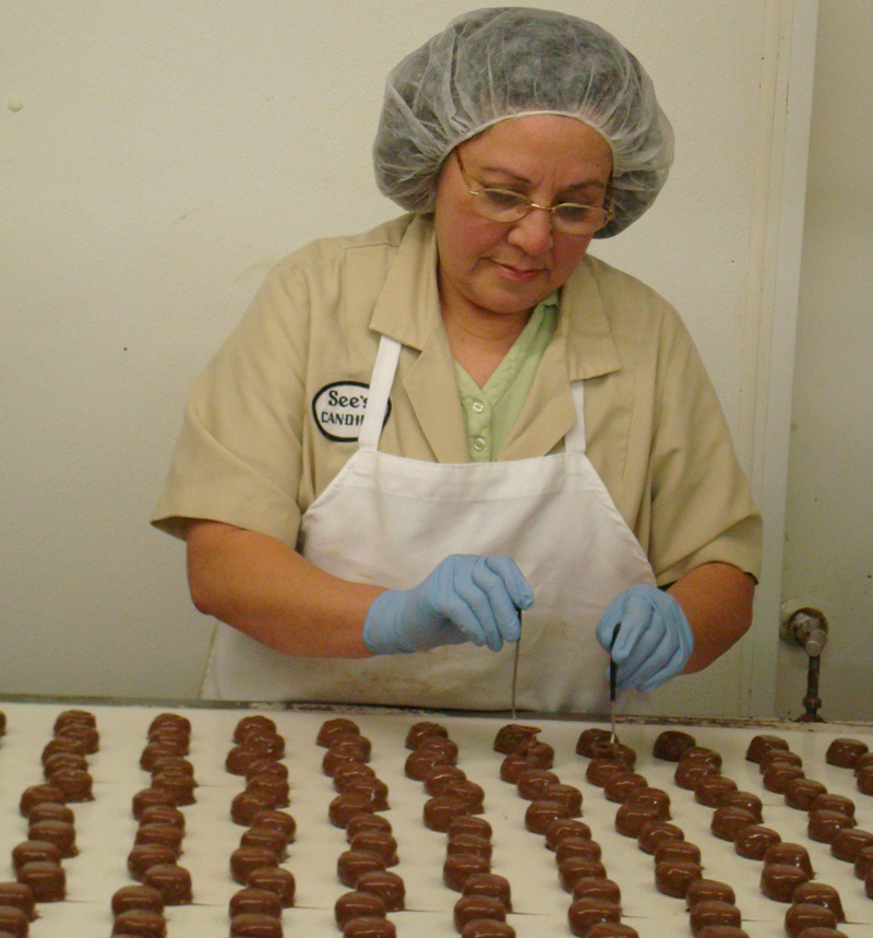 Milk chocolate orange creams get an 'O' put on top of them by hand.