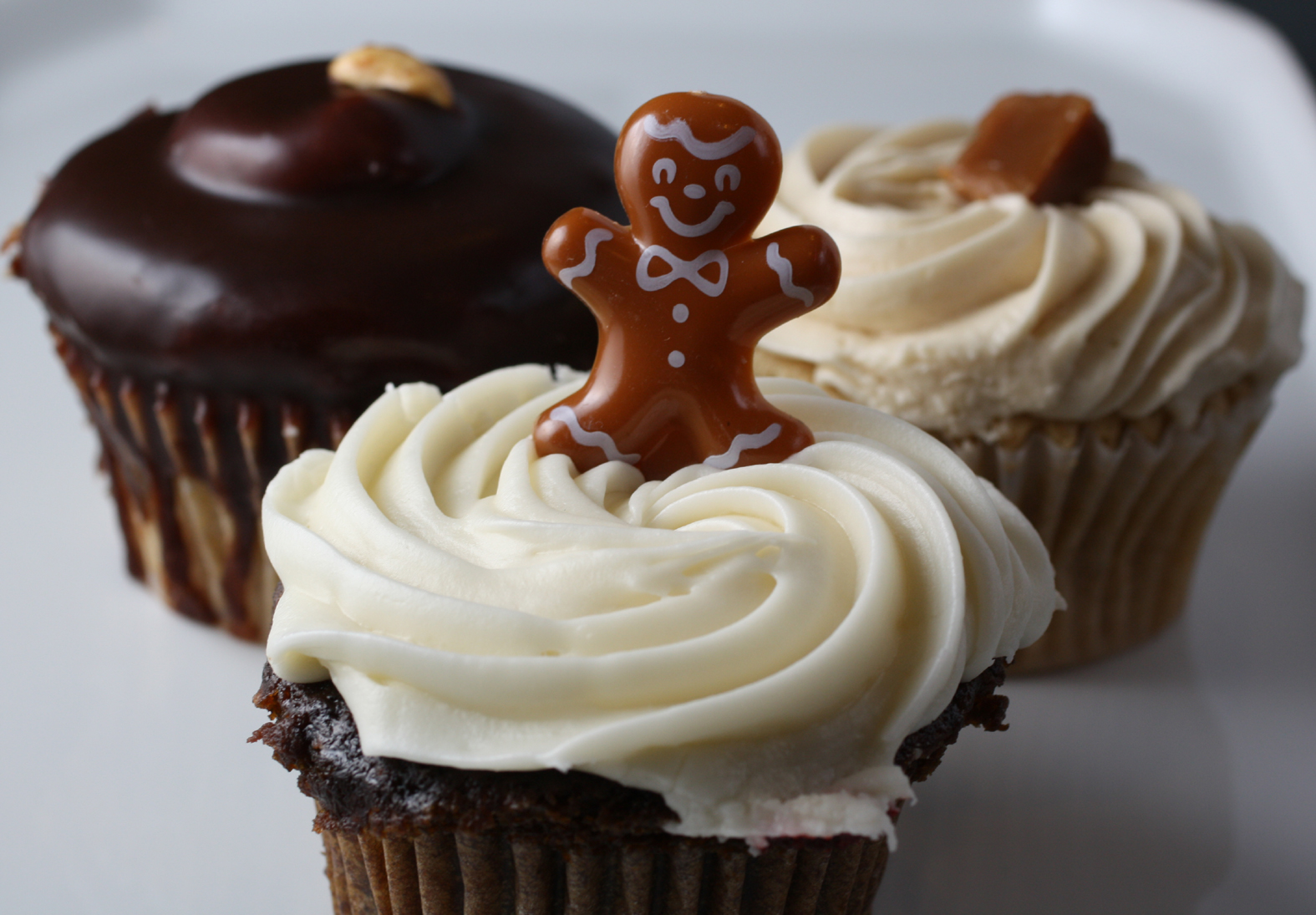 (Clockwise, from back): Peanut butter, caramel, and gingerbread cupcakes.