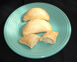 Tender, cheese-filled calcione with a whisper of sweetness. Tender, cheese-filled calcione with a whisper of sweetness.