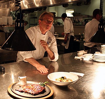 Left Bank Culinary Director Joel Guillon directs the action in the kitchen during a trial run before the opening.