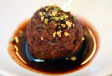 A signature pistachio meatball in a powerful pomegranate sauce.