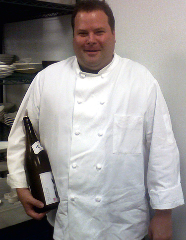 Sous Chef Stuart Morris with one of his favorite sakes. (Photo courtesy of Go Fish restaurant)