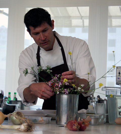 Chef Daniel Patterson of Coi snips edible wild flowers for his heirloom potato dish.