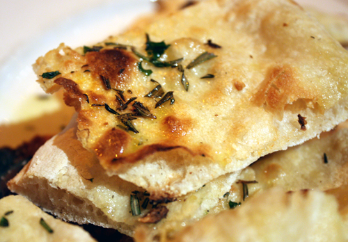 Crisp, warm, and delicious fragrant rosemary pizza slab shards.