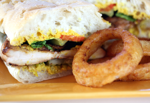 Grilled chicken breast sandwich with incredible onion rings.