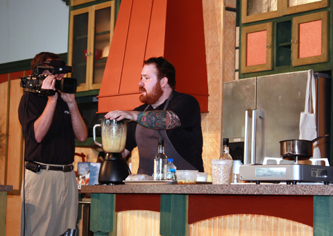 Kevin demonstrating his pork belly dish on stage at the South Carolina food festival.
