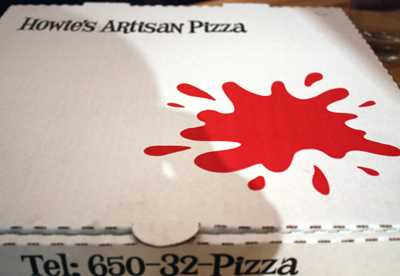 Pizza box with "tomato sauce splat'' logo.