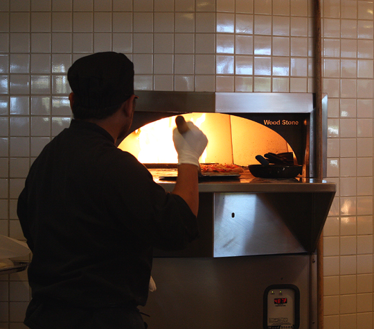 The roaring pizza oven.