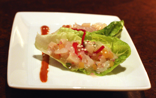 Raw scallops and shrimp with melon and mint in lettuce cups.