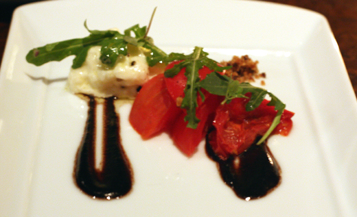 Tomatoes, creamy burrata and a thick, salty black olive vinaigrette.