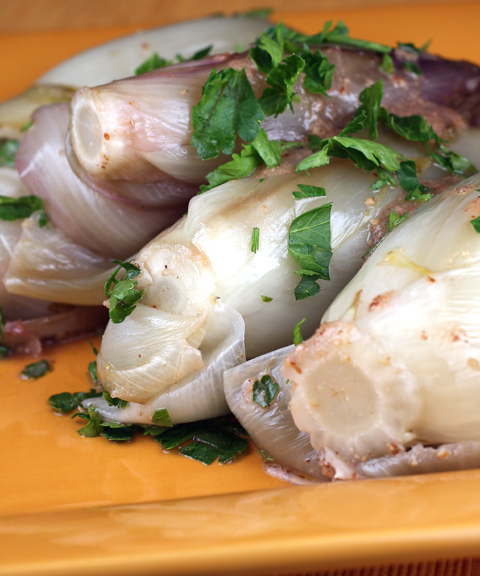 Endive, cooked in chicken stock, then tossed with a mustardy vinaigrette.