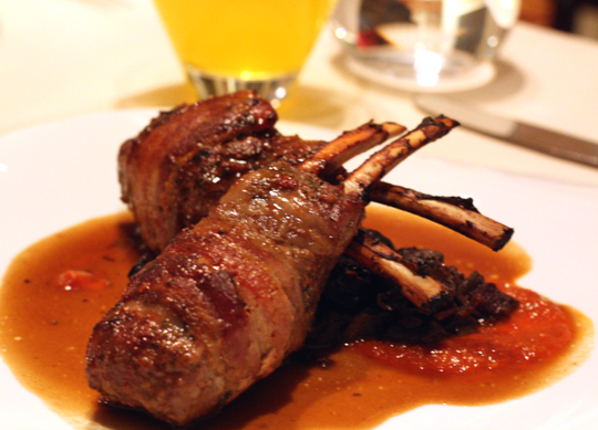 Juicy rack of lamb wrapped in bacon.