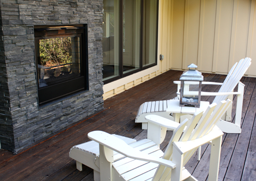 The room's double-sided fireplace can be enjoyed from the deck, too.