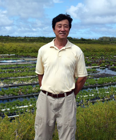 Wenhao Sun stands before his hydroponic farm.
