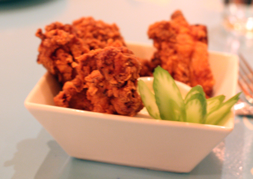 Crunchy-battered fried chicken thighs start the meal.