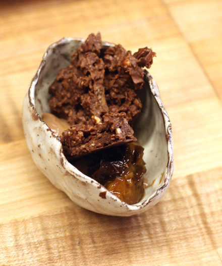 Shards of hazelnut crunch atop chocolate pudding.