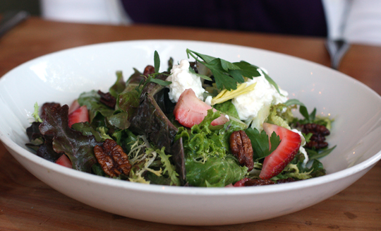 Green salad with spiced pecans and strawberries.