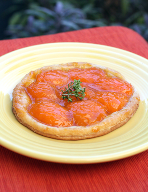 Fresh apricots adorn a round of flaky puff pastry.