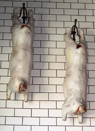 Artwork (not real) that hangs over the entrance to the charcuterie curing room.
