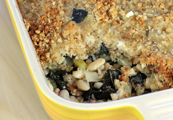 A cheesy crust of bread crumbs hides a filling of creamy white beans and kale.