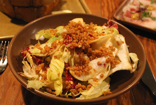 Crumbles of crunchy chicken skin top this chicory salad with apples.