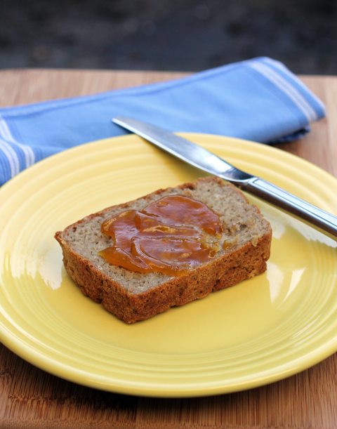 A slice of gluten-free bread fresh out of the oven that's smeared with Mango fruit spread. A slice of gluten-free bread fresh out of the oven that's smeared with Mango fruit spread.