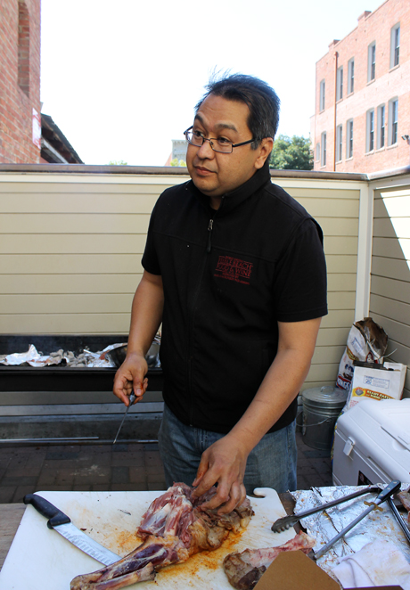 Chef Dave Cruz cooking a whole lamb at his pop-up event.