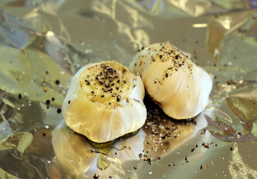 Whole heads of garlic get wrapped in foil...