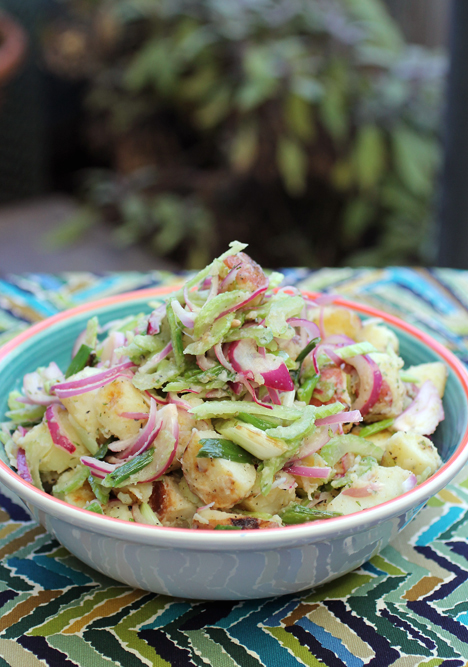 Grilled potato salad with ember-roasted garlic dressing -- to put pizzazz in your Fourth of July.