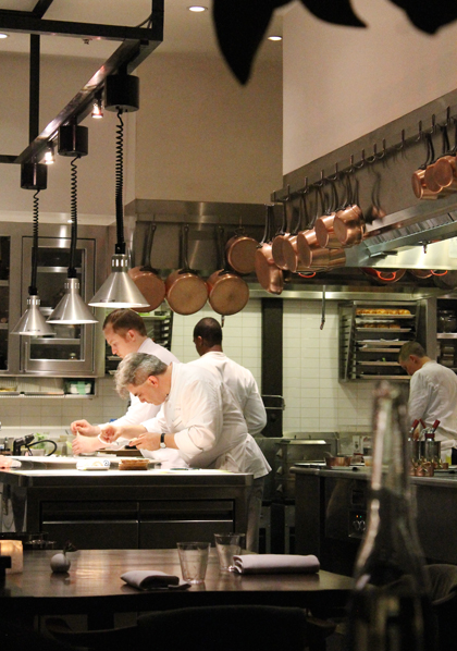 The two chefs assembling a dish.