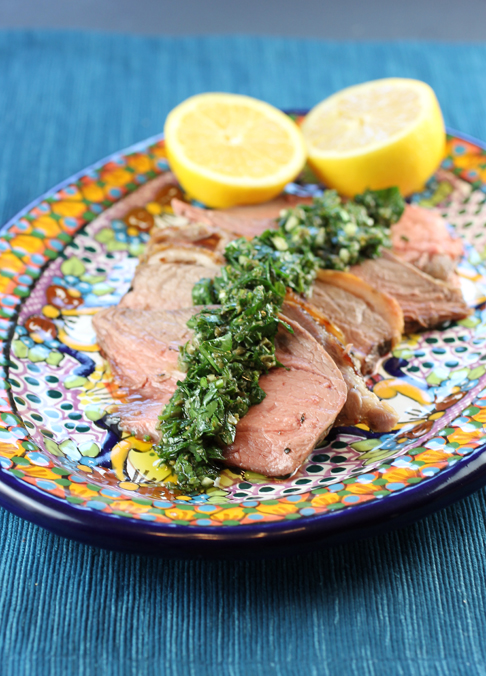 Rosy slices of lamb topped with a vibrant salsa verde.