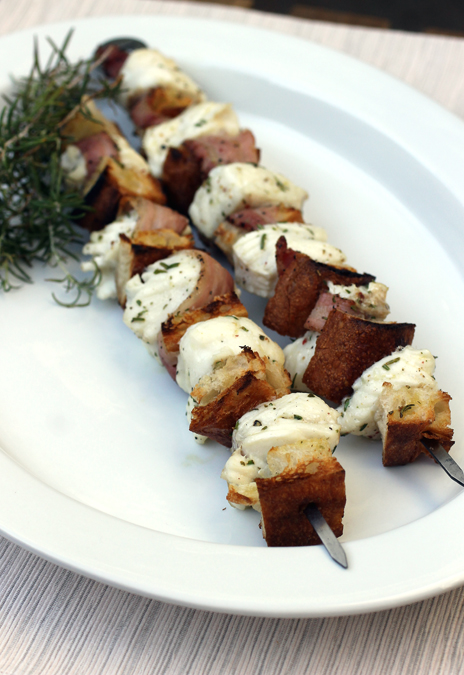 Snowy white halibut chunks get grilled with pancetta and artisan bread cubes for a taste sensation.