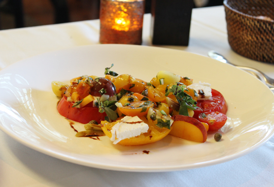Heirloom tomatoes with goat cheese and peaches.