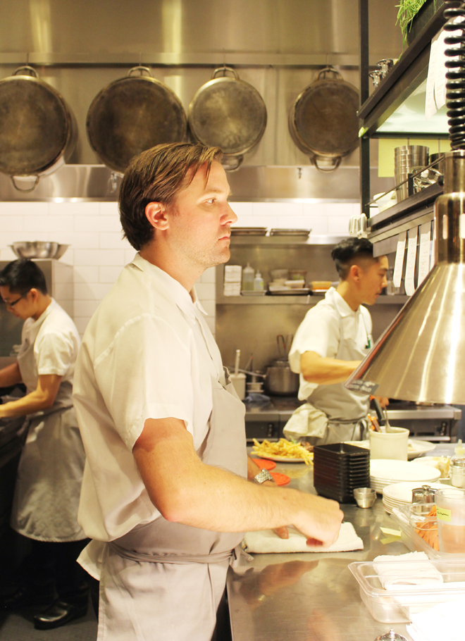 Chef Jason Berthold deep in concentration in the kitchen.