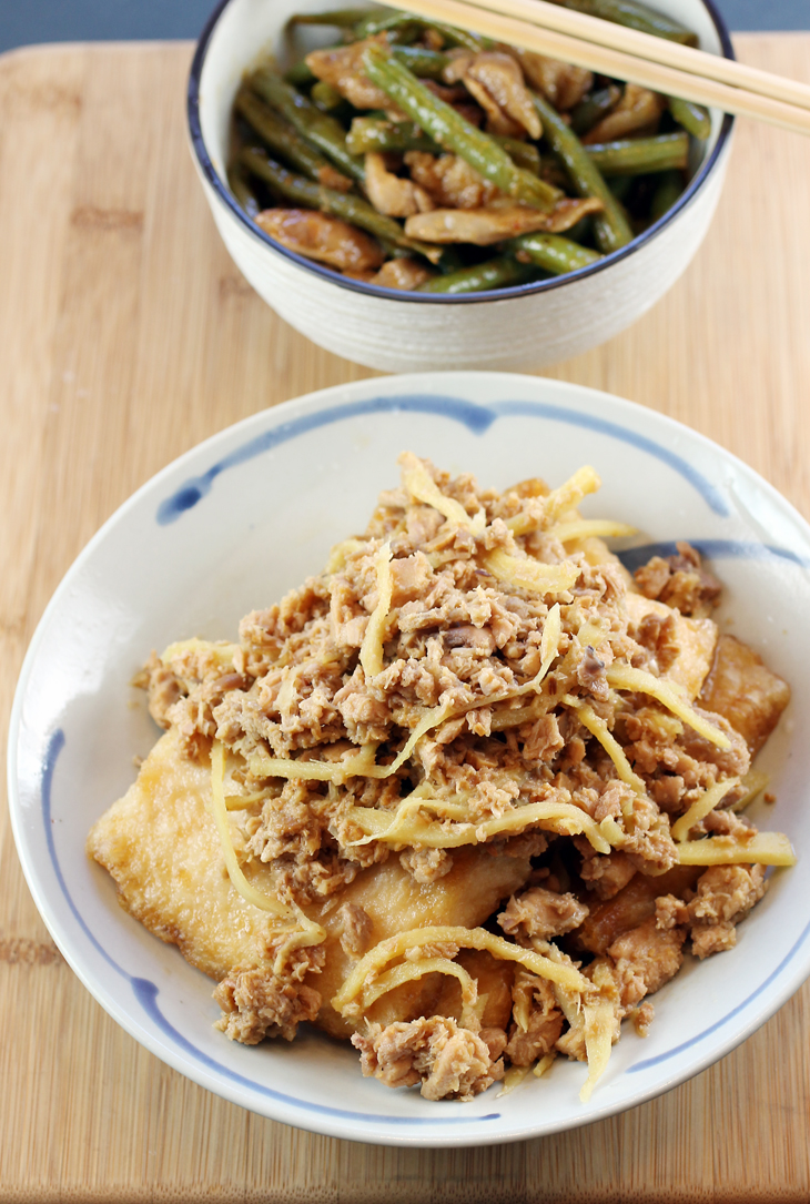 Green beans with pork in a tamarind sauce (back) and fried fish with a jumble of salted beans, ground chicken and shallots from Chez Sovan via way of Delivery.com.