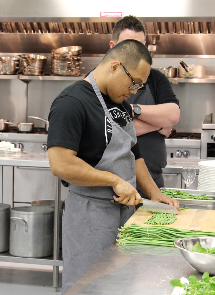 Chef Johnny Madriaga cutting up long beans.