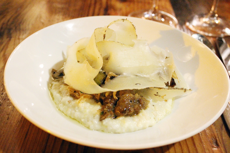 Ribbons of Bohemian Creamery's Capriago cheese cover the top of mushroom-pork ragout with grits at The Table.