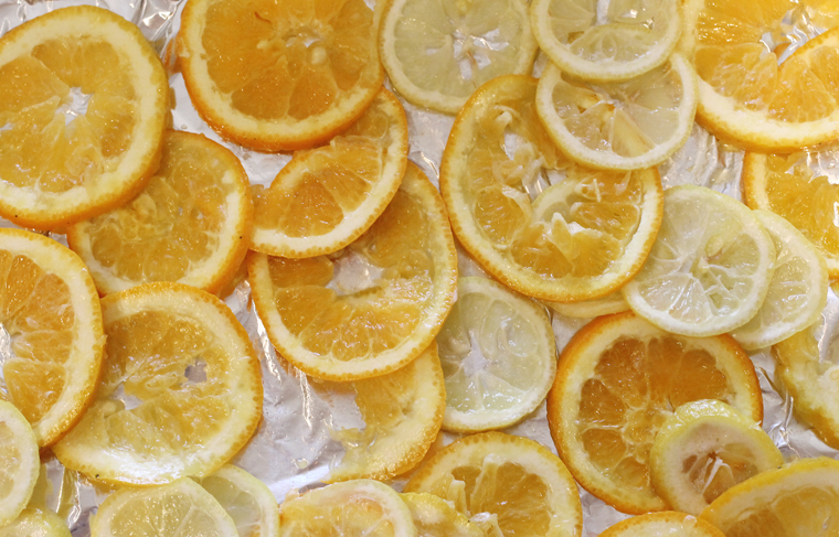Thinly cut lemon and orange slices readied for roasting.