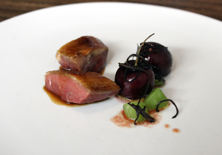 A luscious squab with cherries.