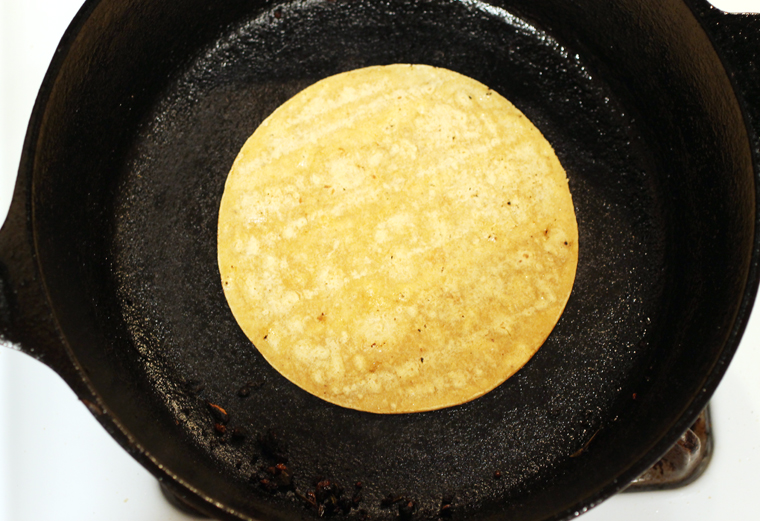 The corn tortillas get warm and slightly puffy.