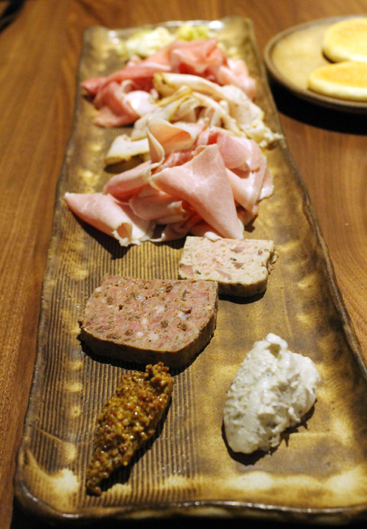 A sampler of charcuterie (almost all house-made) on a one-of-a-kind plate at Pausa.