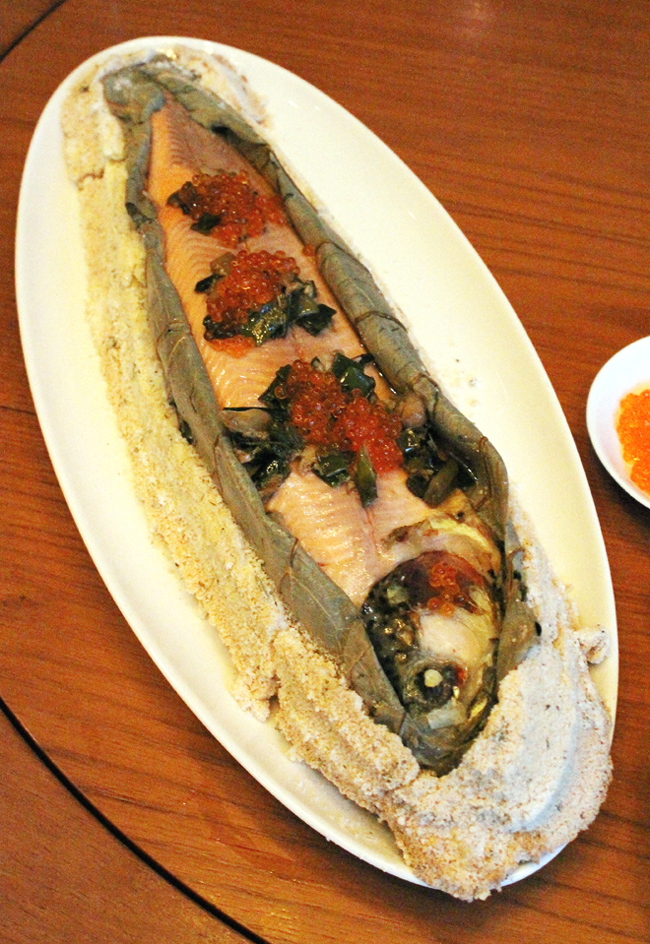 The whole trout, wrapped in lotus leaves and cooked in a salt crust.