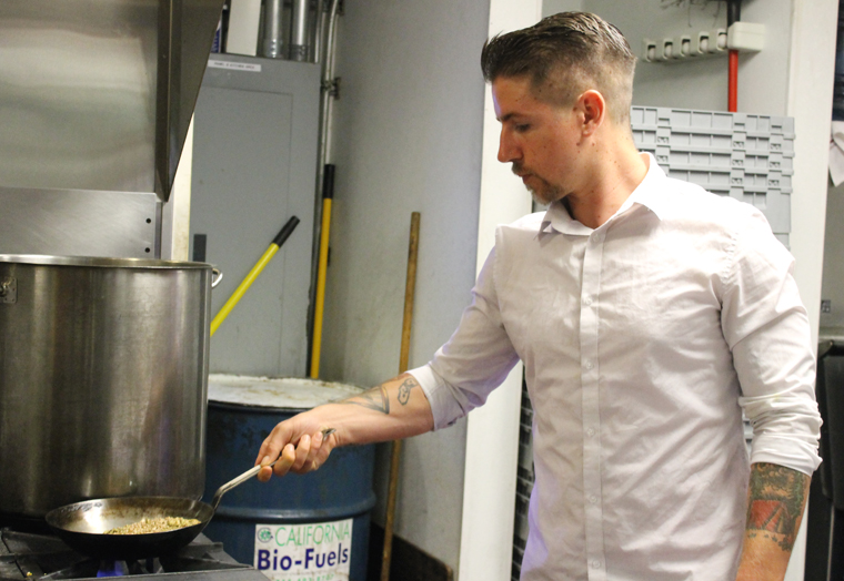 Bar Manager Chase Henriksen takes over the stove to make his turmeric tonic.
