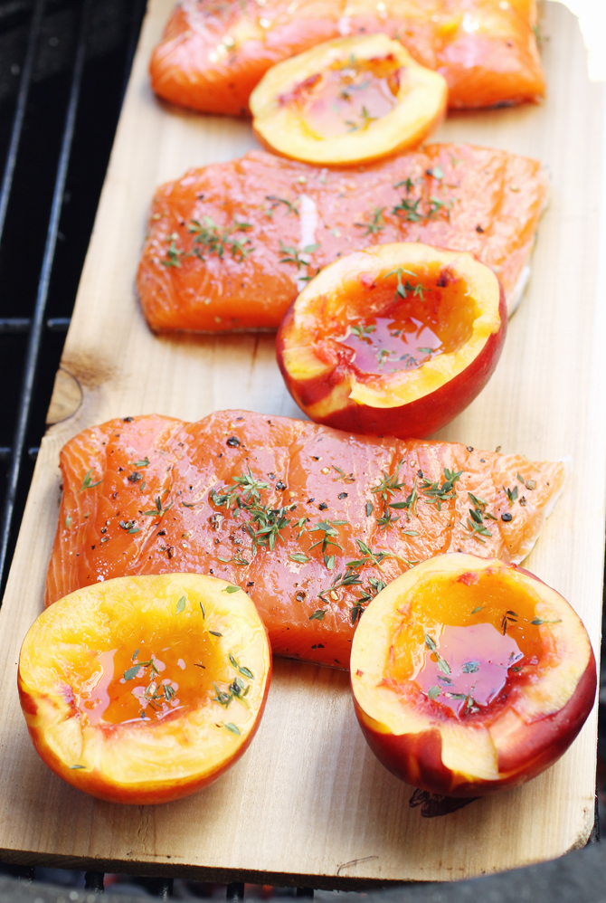 Arranging the salmon and nectarines on the cedar plank just before grilling.