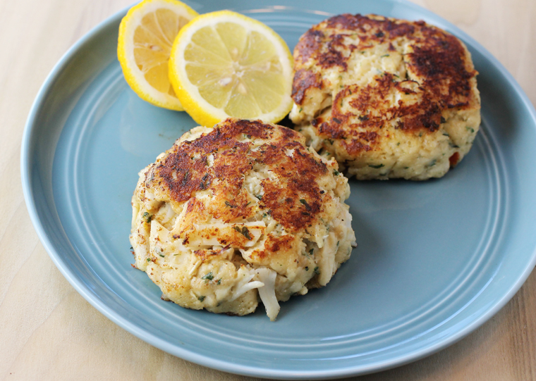 The crab cakes arrive in little sealed plastic cups. Unmold them, and press them down slightly in a frying pan to sear.