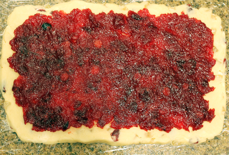 Spread the jam on the rolled-out dough.