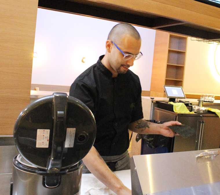 Chef Salvador Alvarez at the bar, making hand rolls during the media event.
