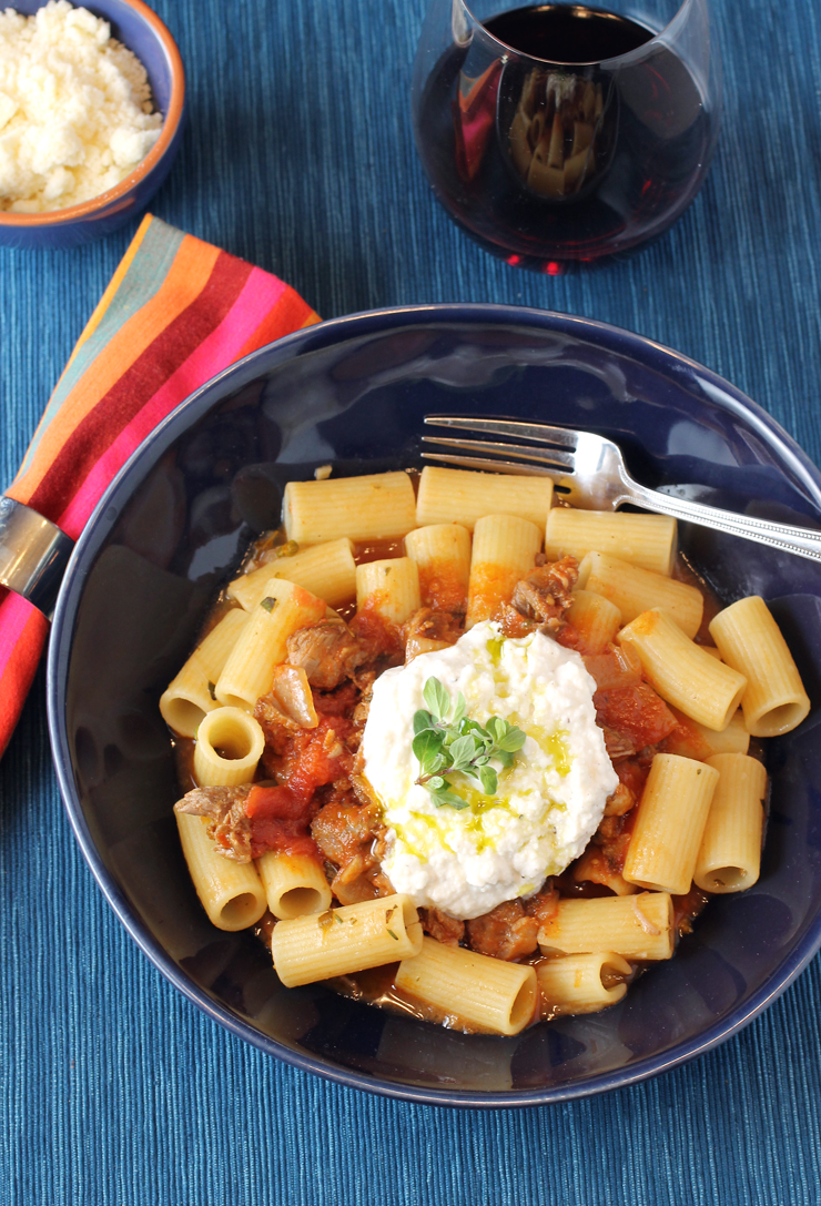 Whipped ricotta with a drizzle of extra-virgin olive oil finish this lamb ragu with rigatoni.