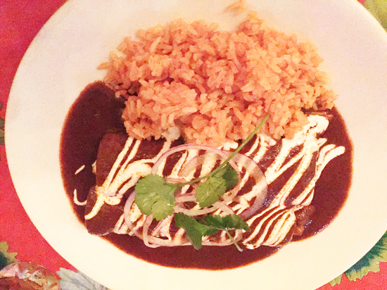 Chicken mole enchiladas with rice.